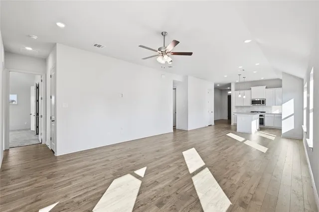 a living room with kitchen island furniture and a kitchen view