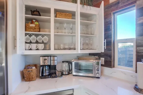 a kitchen with stainless steel appliances granite countertop a stove and a white cabinets