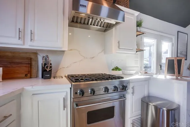 a bedroom with bed and a washing machine with the side of it