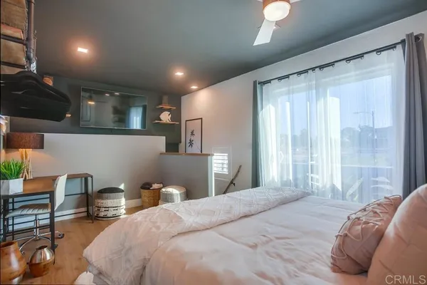 a bedroom with a bed and a lamp with window