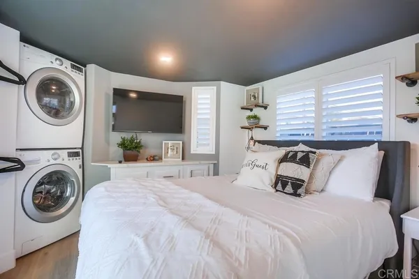 a bedroom with a bed and a large window with the outer view