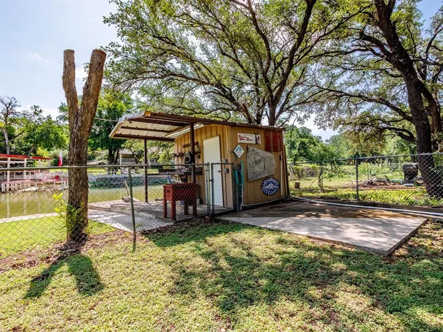 a view of a backyard with swimming pool