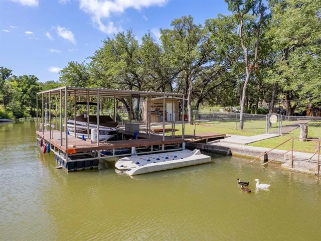 a view of a swimming pool with chairs in roof deck