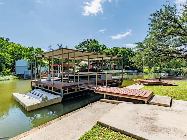 a view of a swimming pool with a patio and a yard