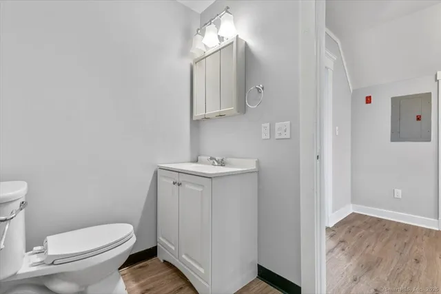 a white toilet sitting next to a bathroom sink