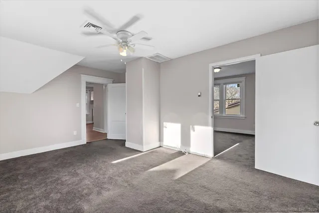 a view of a livingroom with a ceiling fan and window