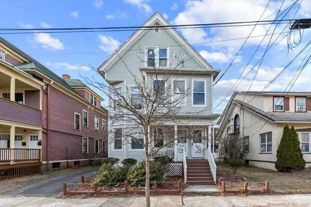 a front view of a house with a street
