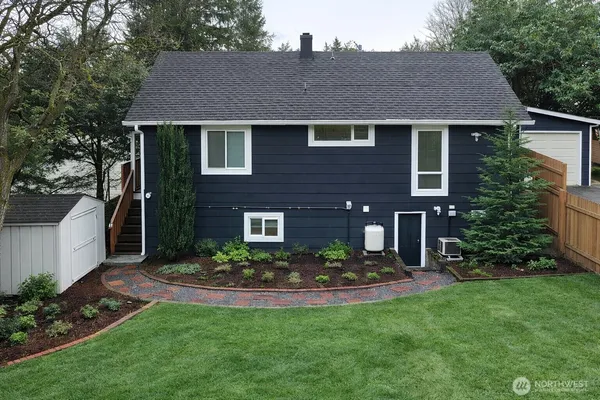 a front view of house with a garden