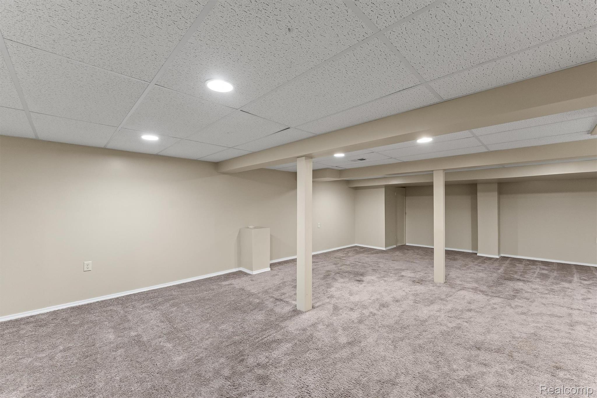 2118 Rutgers Drive Troy, MI 48085 - Photo 27 of 39 Spacious finished basement featuring recessed lighting, a drop ceiling, neutral gray carpet, and light beige wall paint