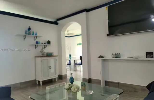 a kitchen with granite countertop a stove cabinets and refrigerator