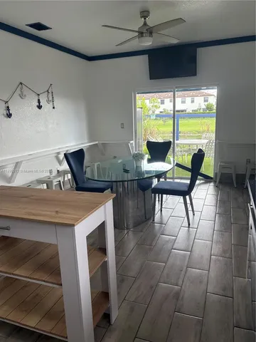 a kitchen with kitchen island granite countertop a sink cabinets and stainless steel appliances