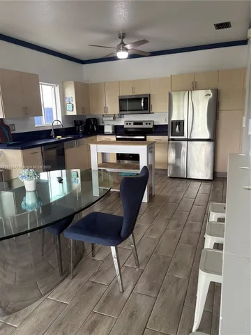 a kitchen with sink stove and refrigerator