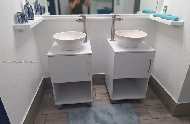 a white toilet sitting next to a shower curtain