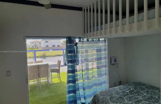 a view of a dining room with furniture and a window