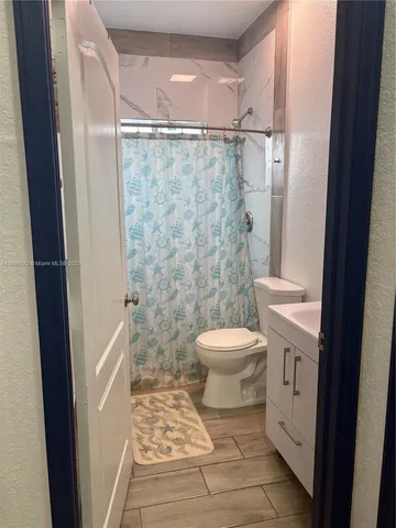 a bathroom with a toilet and a shower