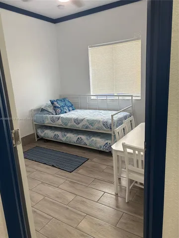 a bedroom with a bed and window