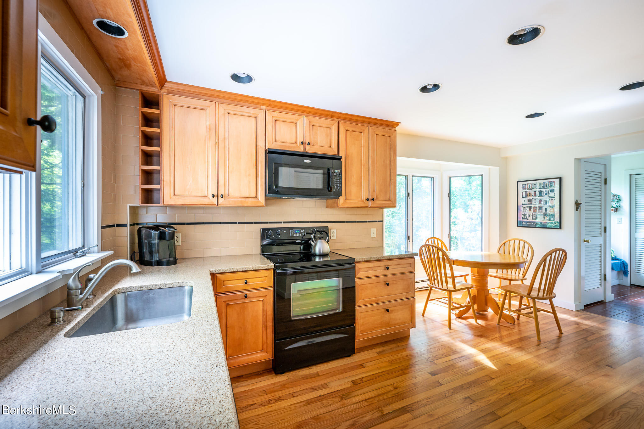 9 Pixley Hill Road West Stockbridge, MA 01236 - Photo 9 of 37 a kitchen with stainless steel appliances granite countertop a stove top oven a sink a dining table and chairs with wooden floor