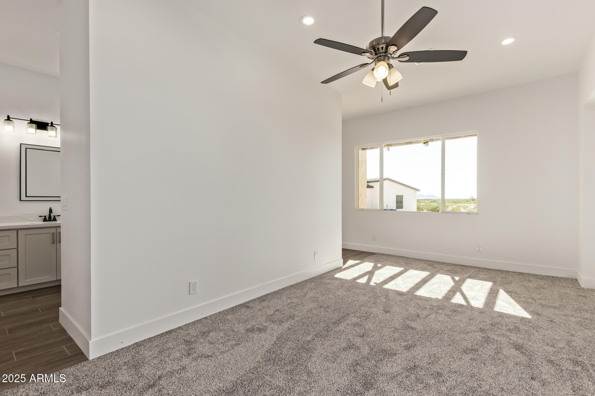 23167 West Montgomery Road Wittmann, AZ 85361 - Photo 13 of 44 an empty room with windows and fan