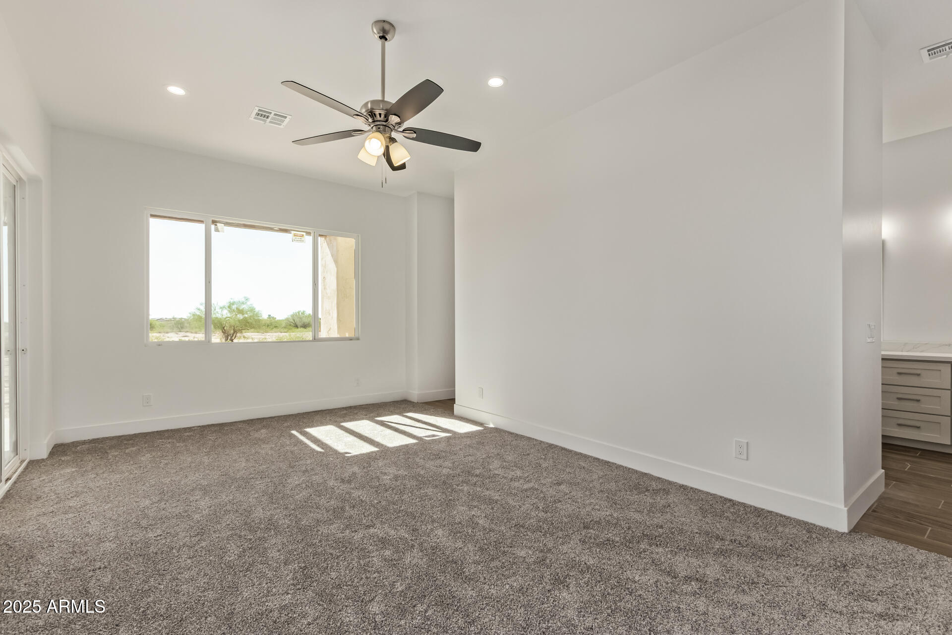 23167 West Montgomery Road Wittmann, AZ 85361 - Photo 20 of 44 an empty room with windows and fan