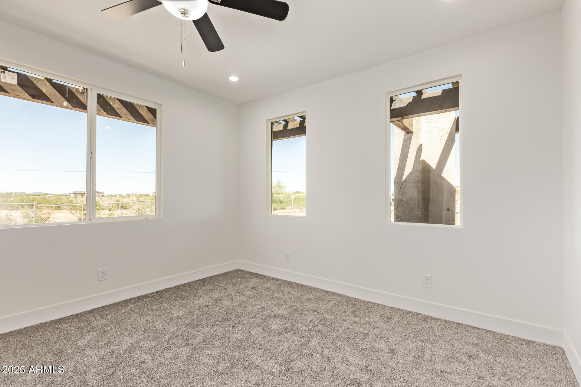 23167 West Montgomery Road Wittmann, AZ 85361 - Photo 26 of 44 an empty room with a window and ceiling fan
