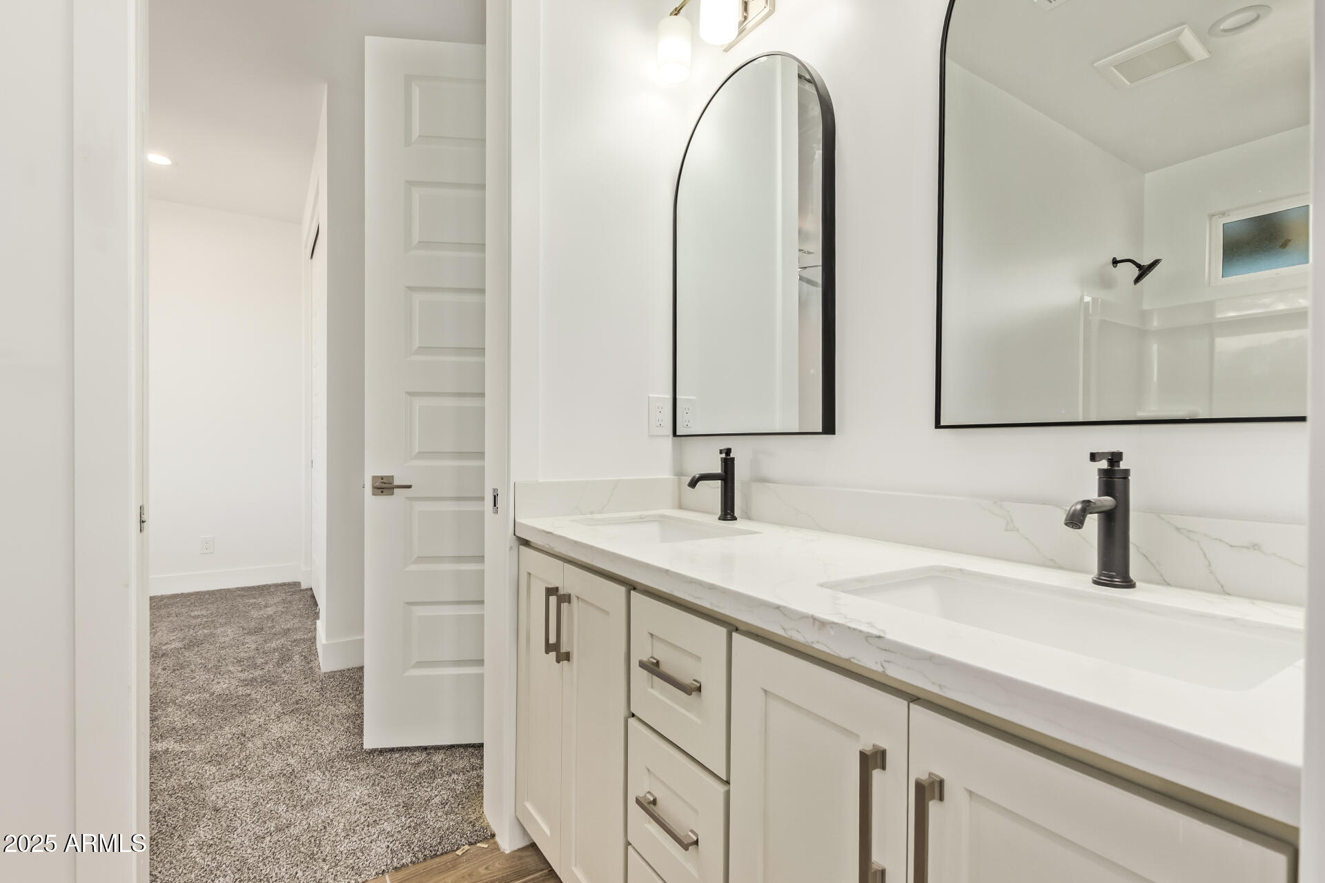 23167 West Montgomery Road Wittmann, AZ 85361 - Photo 28 of 44 a bathroom with a double vanity sink and a mirror