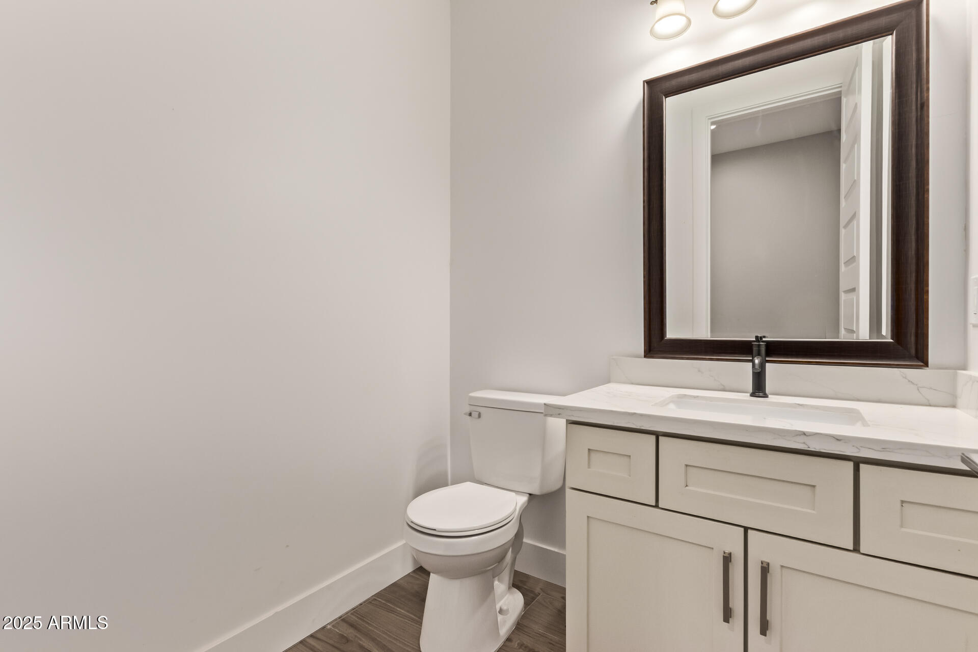 23167 West Montgomery Road Wittmann, AZ 85361 - Photo 31 of 44 a bathroom with a toilet sink and mirror