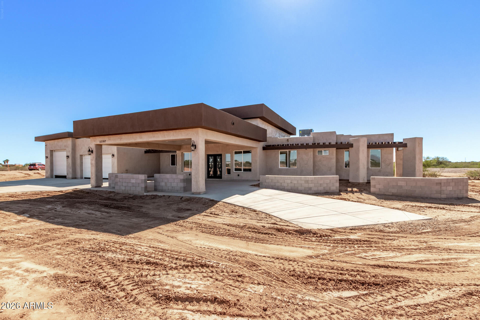 23167 West Montgomery Road Wittmann, AZ 85361 - Photo 40 of 44 a front view of a house with a yard