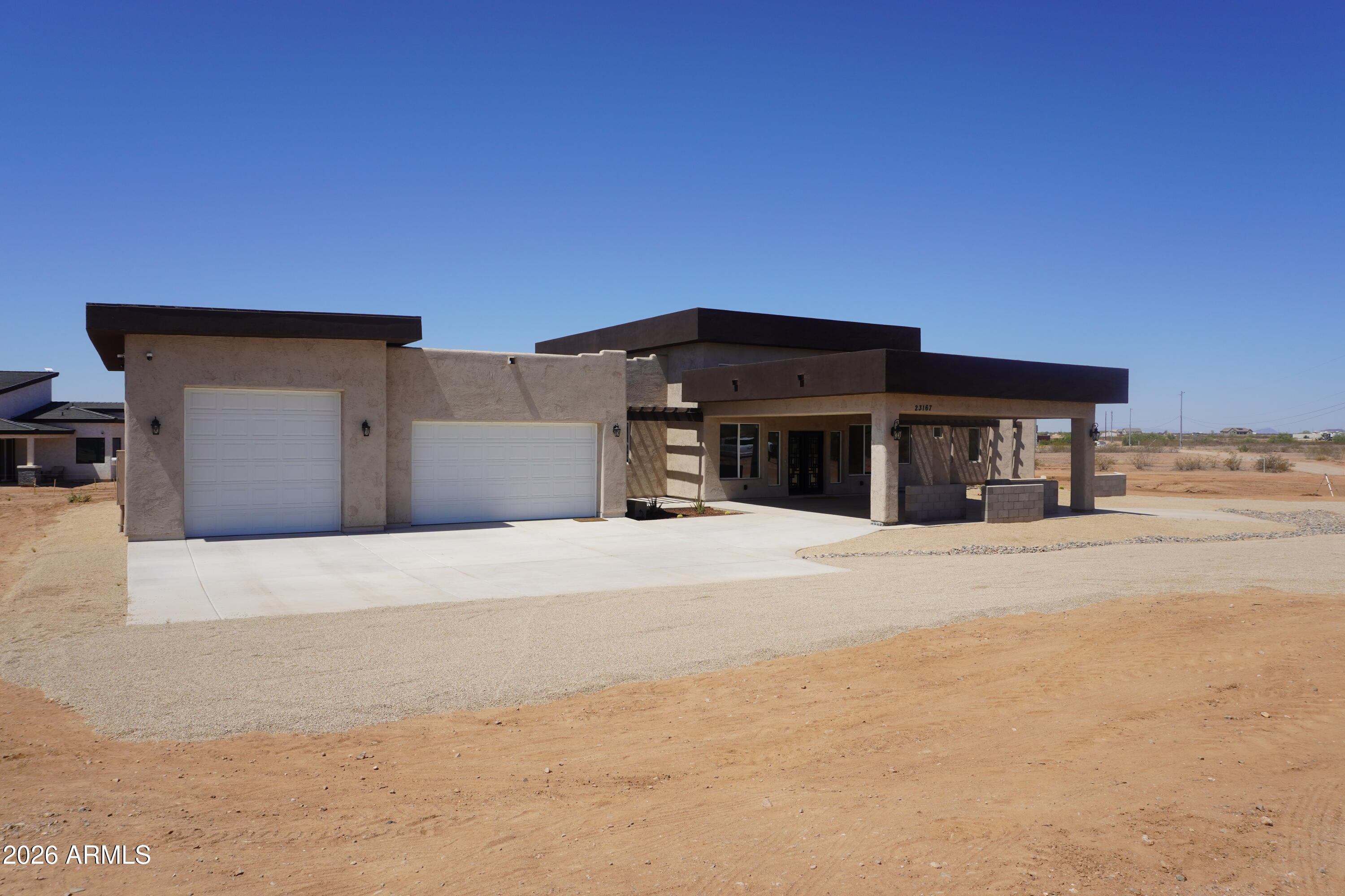 23167 West Montgomery Road Wittmann, AZ 85361 - Photo 4 of 44 a view of a house with a outdoor space