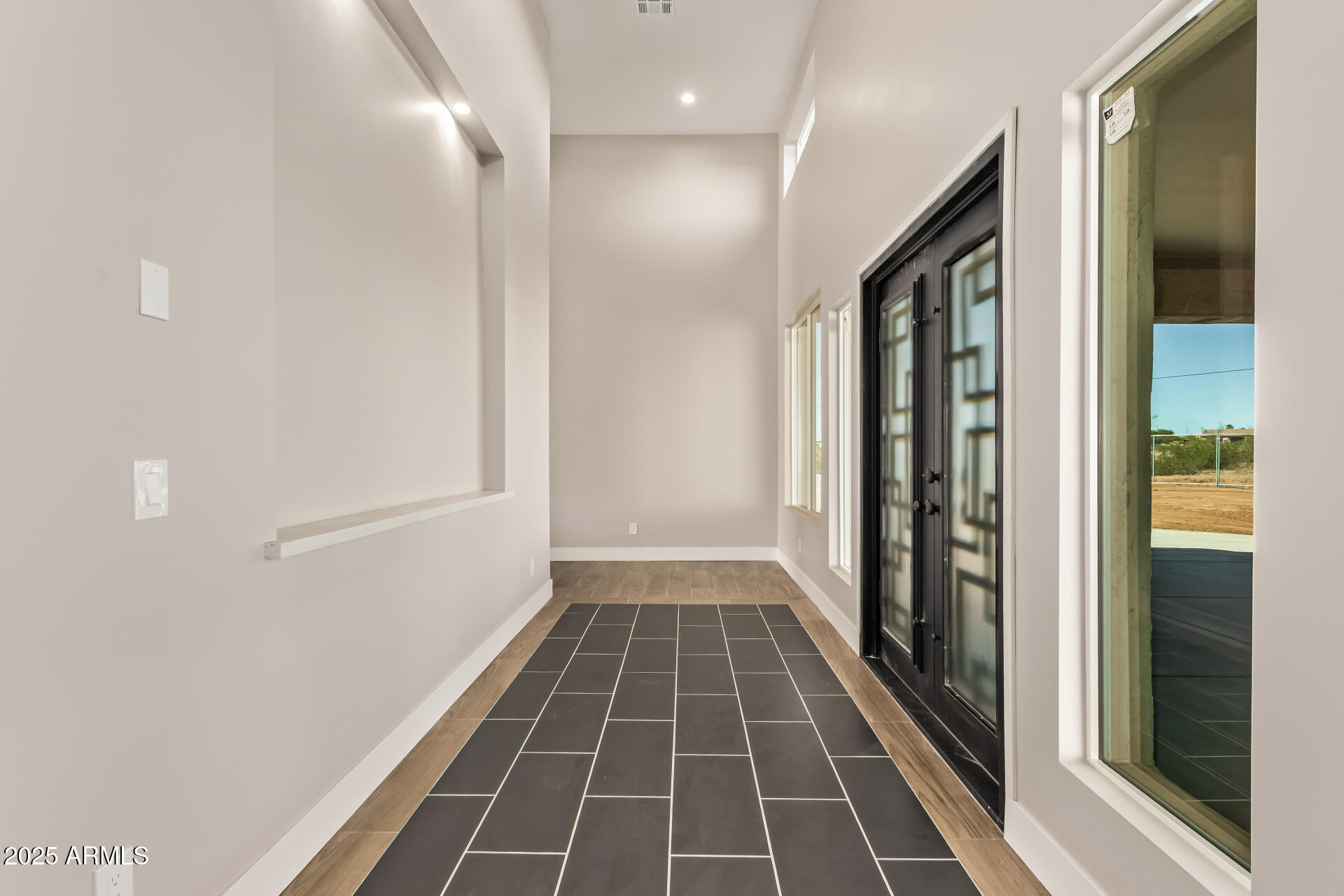 23167 West Montgomery Road Wittmann, AZ 85361 - Photo 8 of 44 a view of a hallway with wooden floor and a bathroom