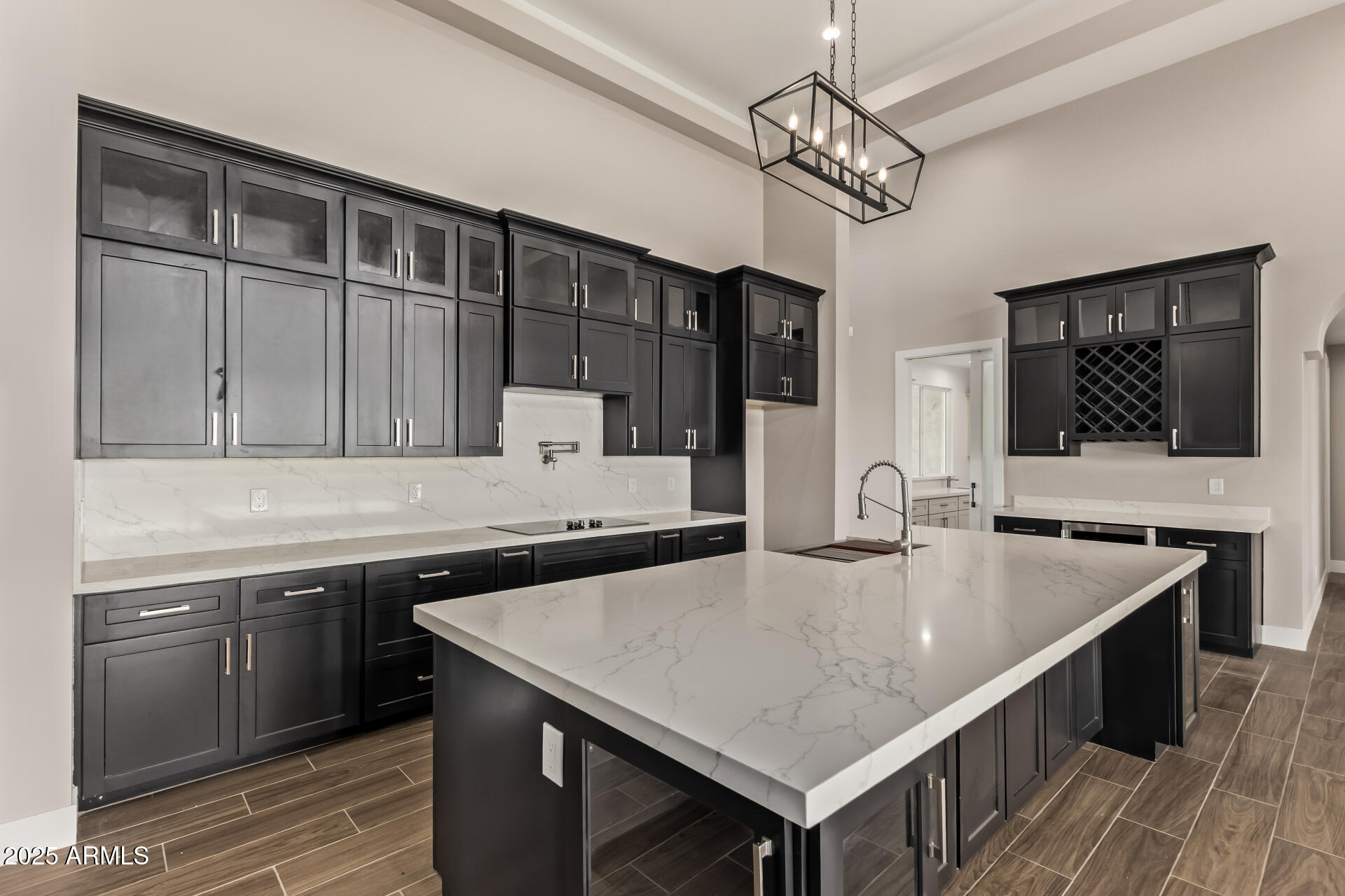 23167 West Montgomery Road Wittmann, AZ 85361 - Photo 10 of 44 a kitchen with a stove a sink dishwasher a kitchen island with wooden cabinets and floor