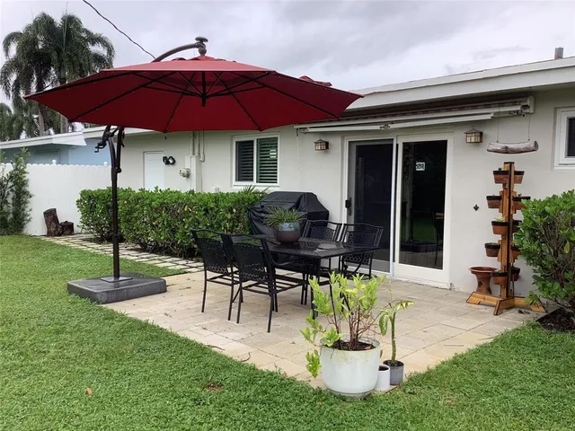 a house view with a seating space and garden
