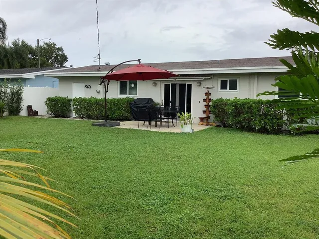 a front view of house with yard and outdoor seating