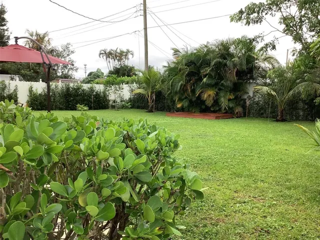 a backyard of a house with lots of green space