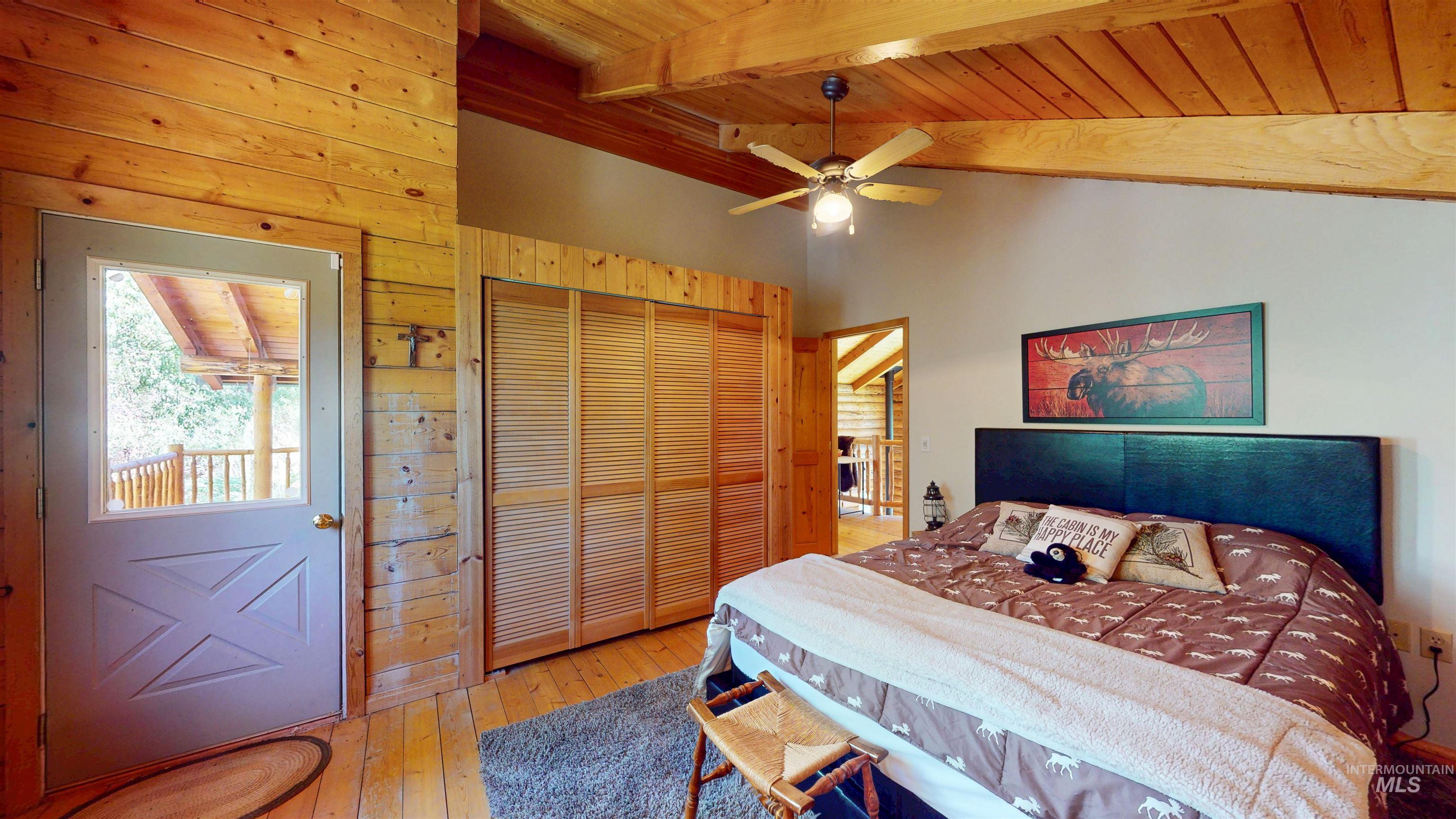 1314 River Road Buhl, ID 83316 - Photo 21 of 45 Bedroom with wooden walls, wooden ceiling, hardwood / wood-style flooring, a closet, and ceiling fan