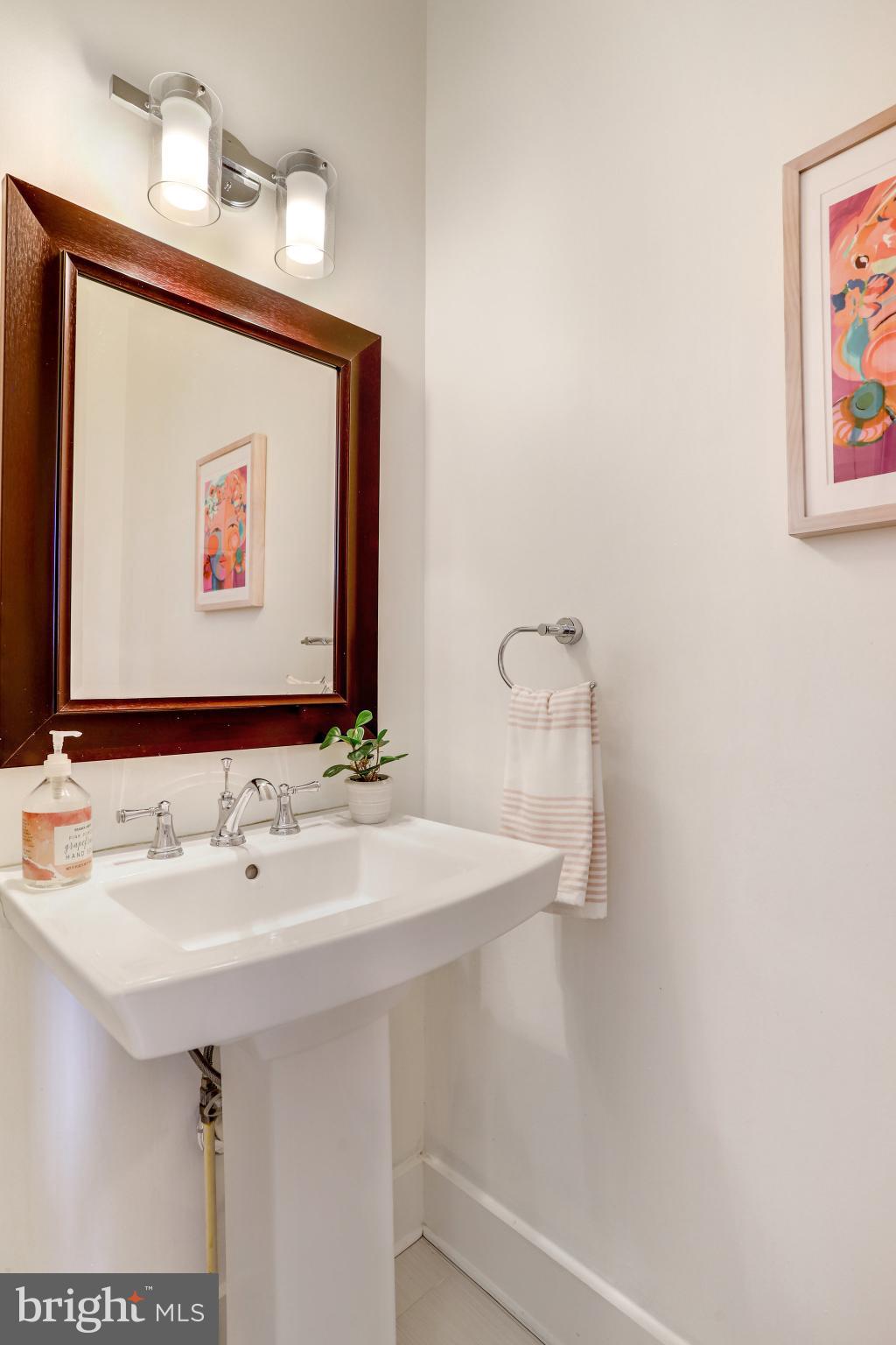 1304 E Street Northeast Washington, DC 20002 - Photo 12 of 42 a bathroom with a sink and a mirror