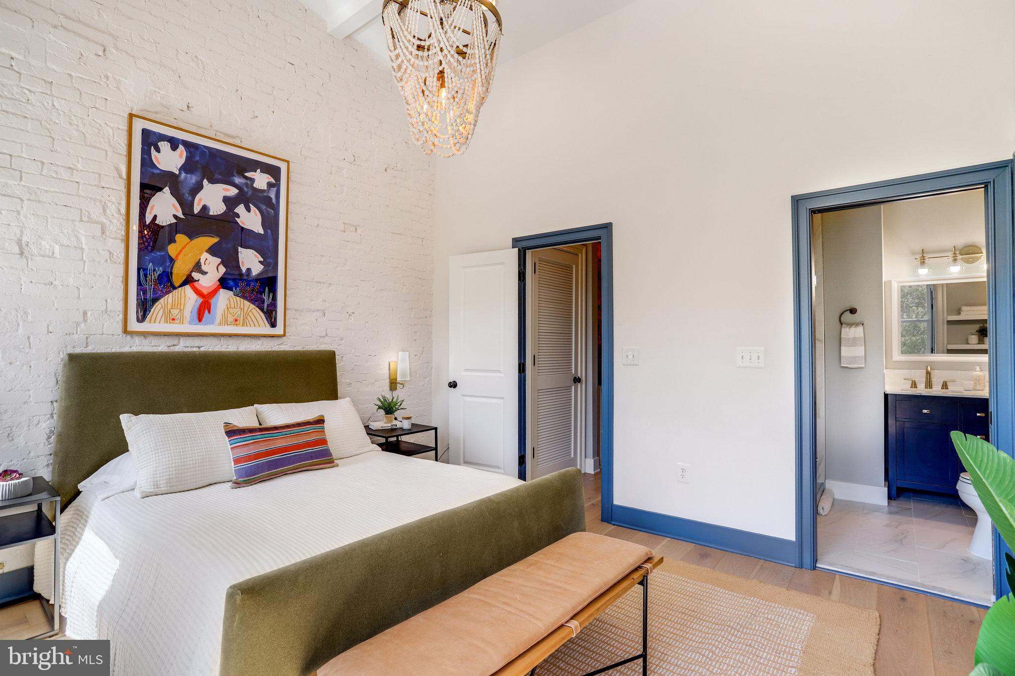 1304 E Street Northeast Washington, DC 20002 - Photo 16 of 42 a bedroom with a bed and a painting on the wall