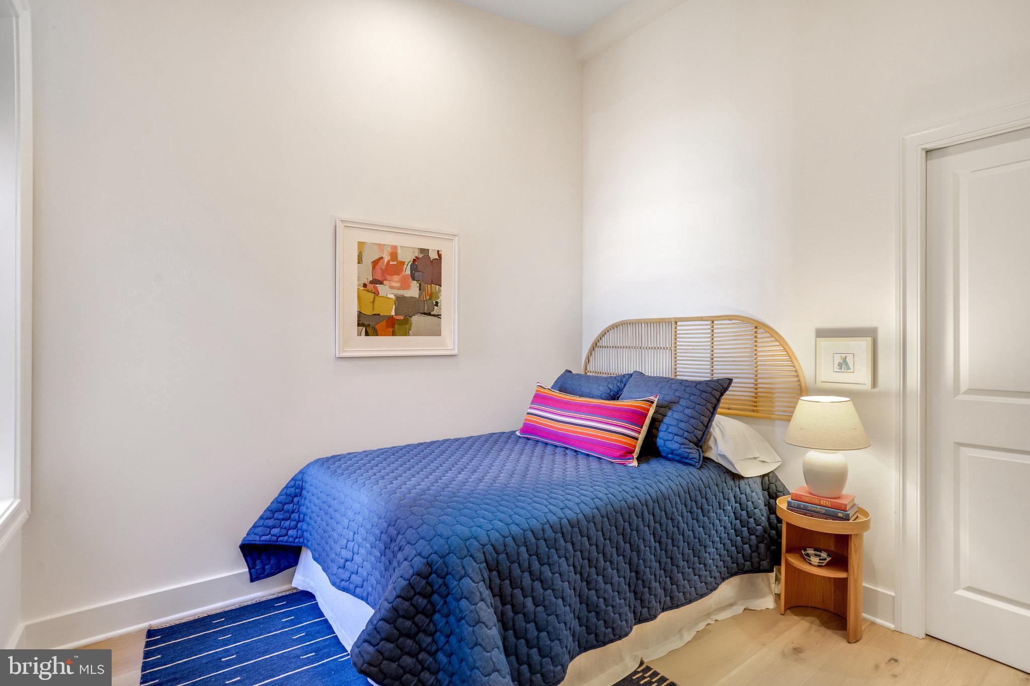 1304 E Street Northeast Washington, DC 20002 - Photo 19 of 42 a bedroom with a bed and wooden floor