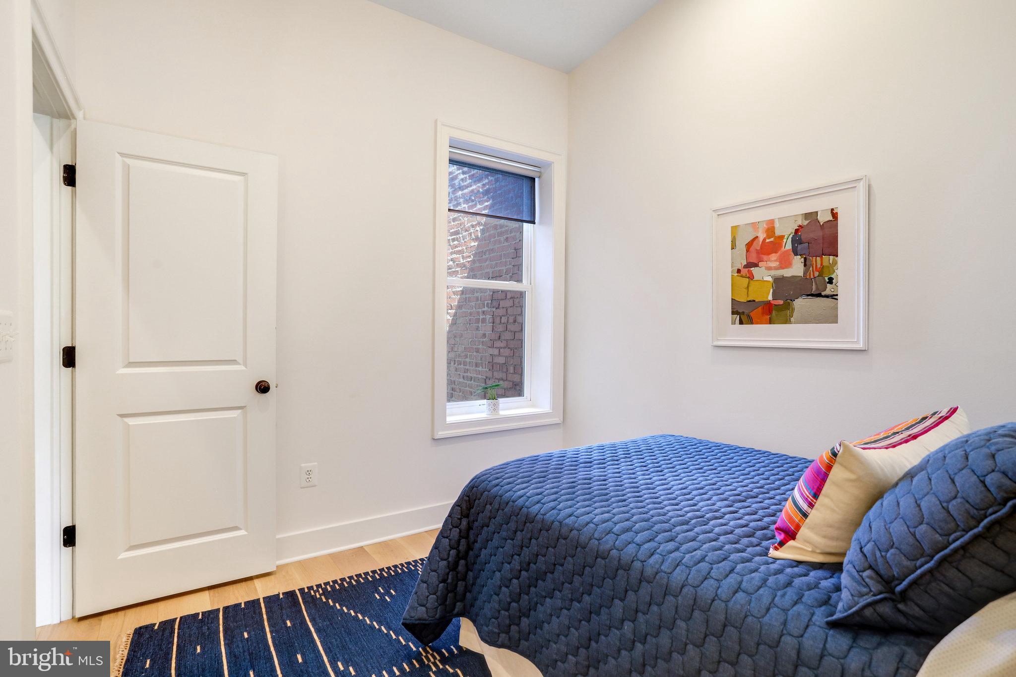 1304 E Street Northeast Washington, DC 20002 - Photo 20 of 42 a bedroom with a bed and a window