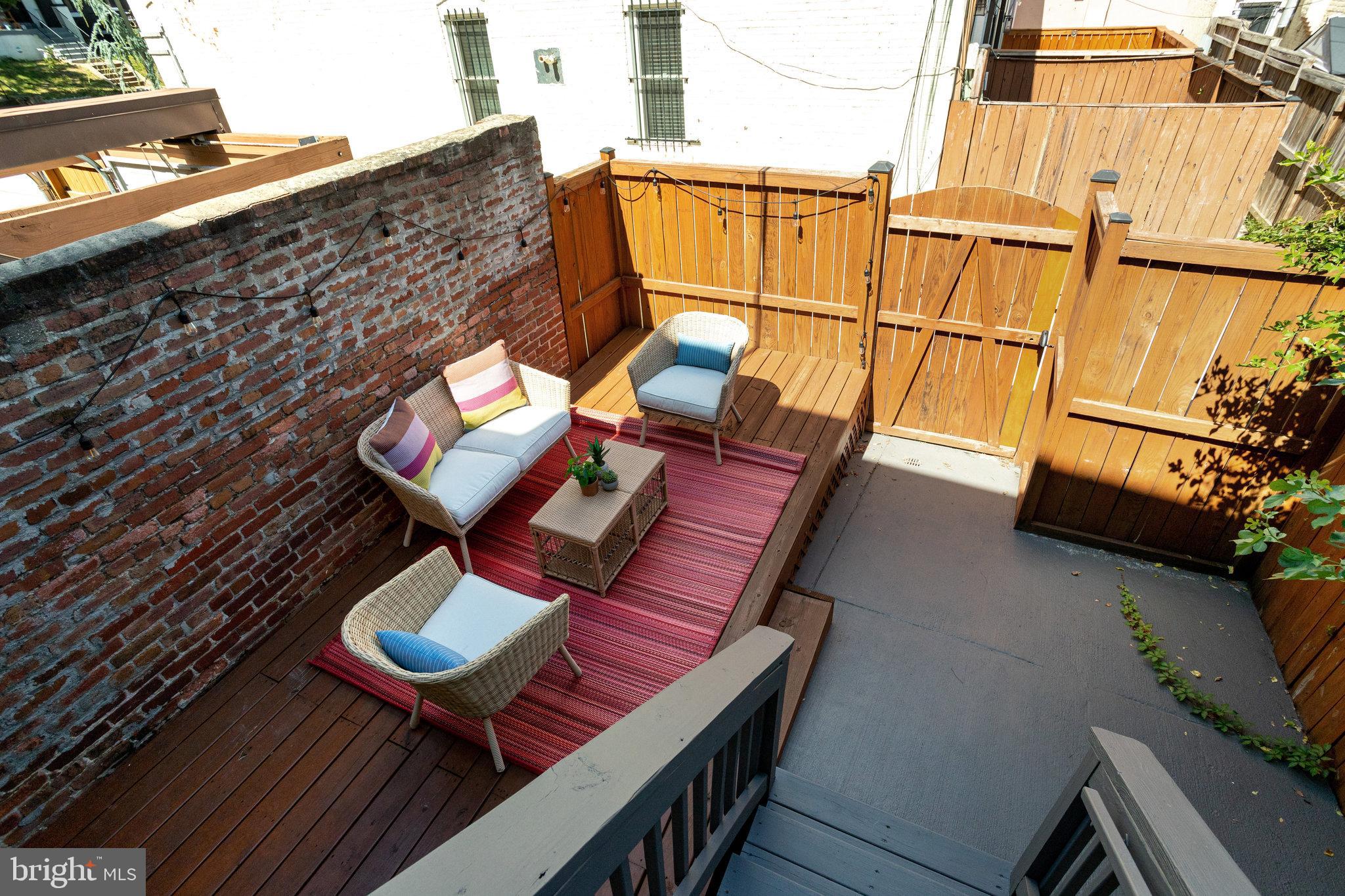 1304 E Street Northeast Washington, DC 20002 - Photo 34 of 42 a outdoor sitting area with furniture and wooden floor