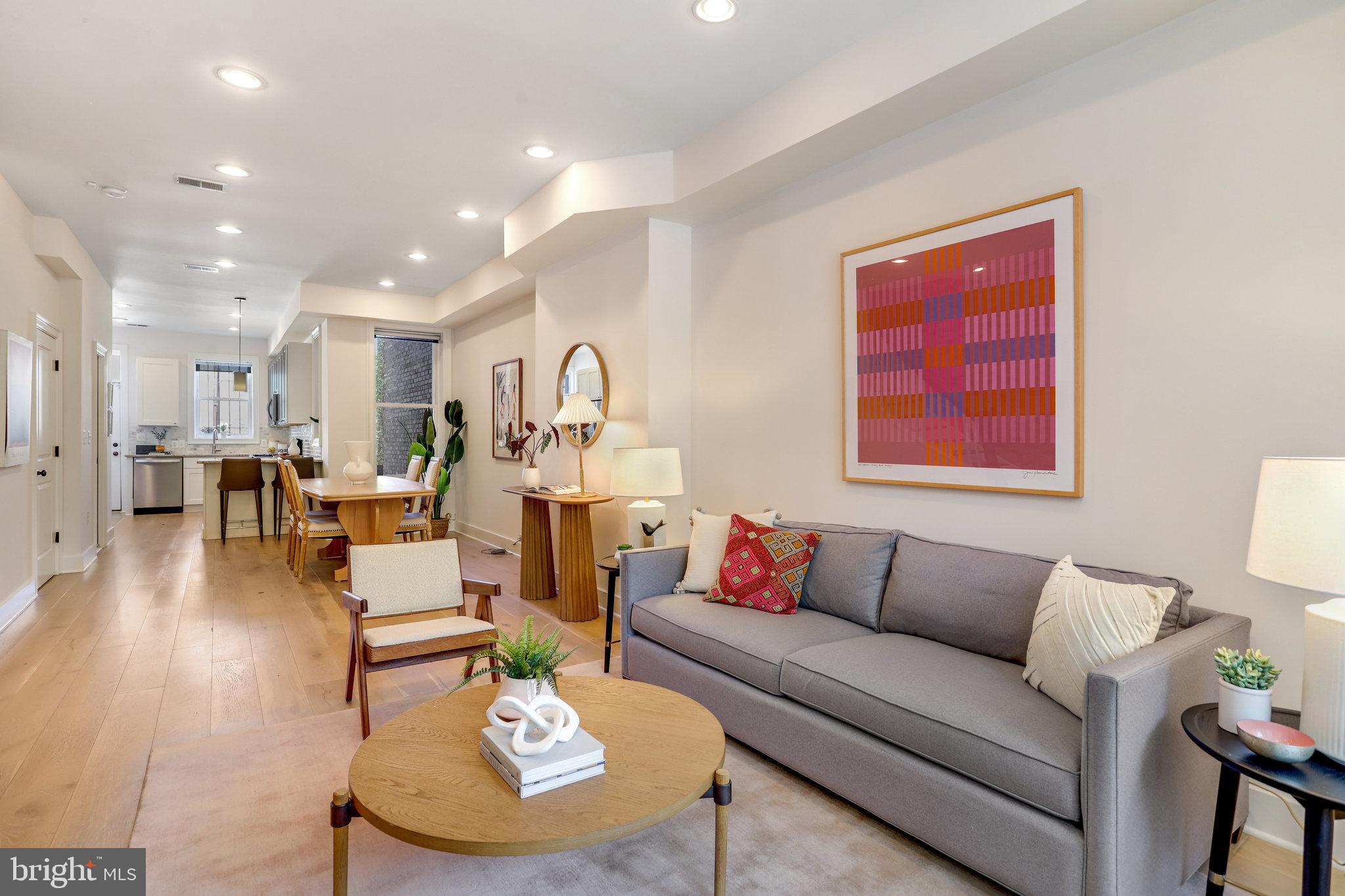 1304 E Street Northeast Washington, DC 20002 - Photo 6 of 42 a living room with furniture kitchen view and a wooden floor