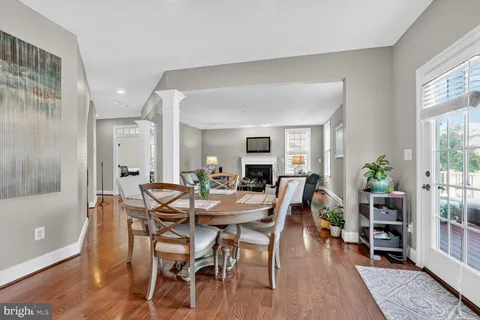 a view of a dining room with furniture and a potted plant