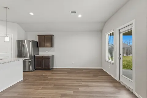 a view of a kitchen with a sink and a refrigerator