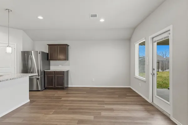 a view of a kitchen with a sink and a refrigerator