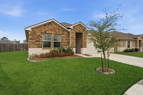 a view of a house with a yard and a garden