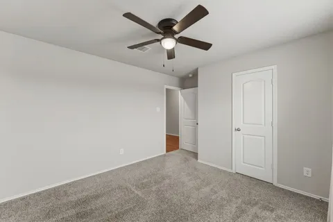 an empty room with ceiling fan