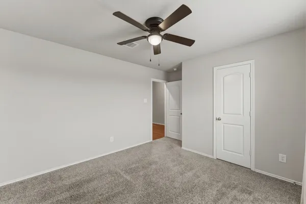 an empty room with ceiling fan