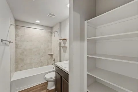 a bathroom with a shower a toilet and a sink