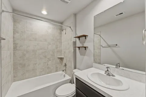 a bathroom with a sink toilet and shower