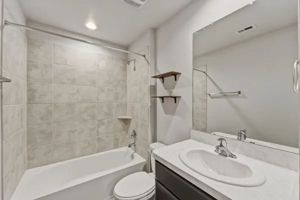a bathroom with a sink toilet and shower