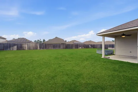 a view of a house with a backyard